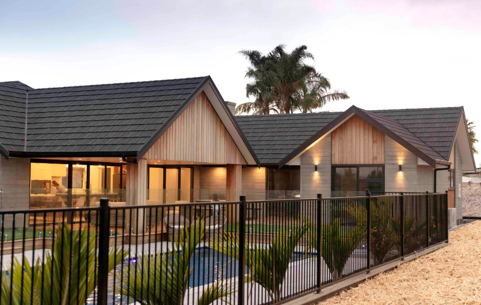 A high-end residential home with premium metal tile roofing installed by RJS Roofing, showcasing expert craftsmanship and long-lasting protection