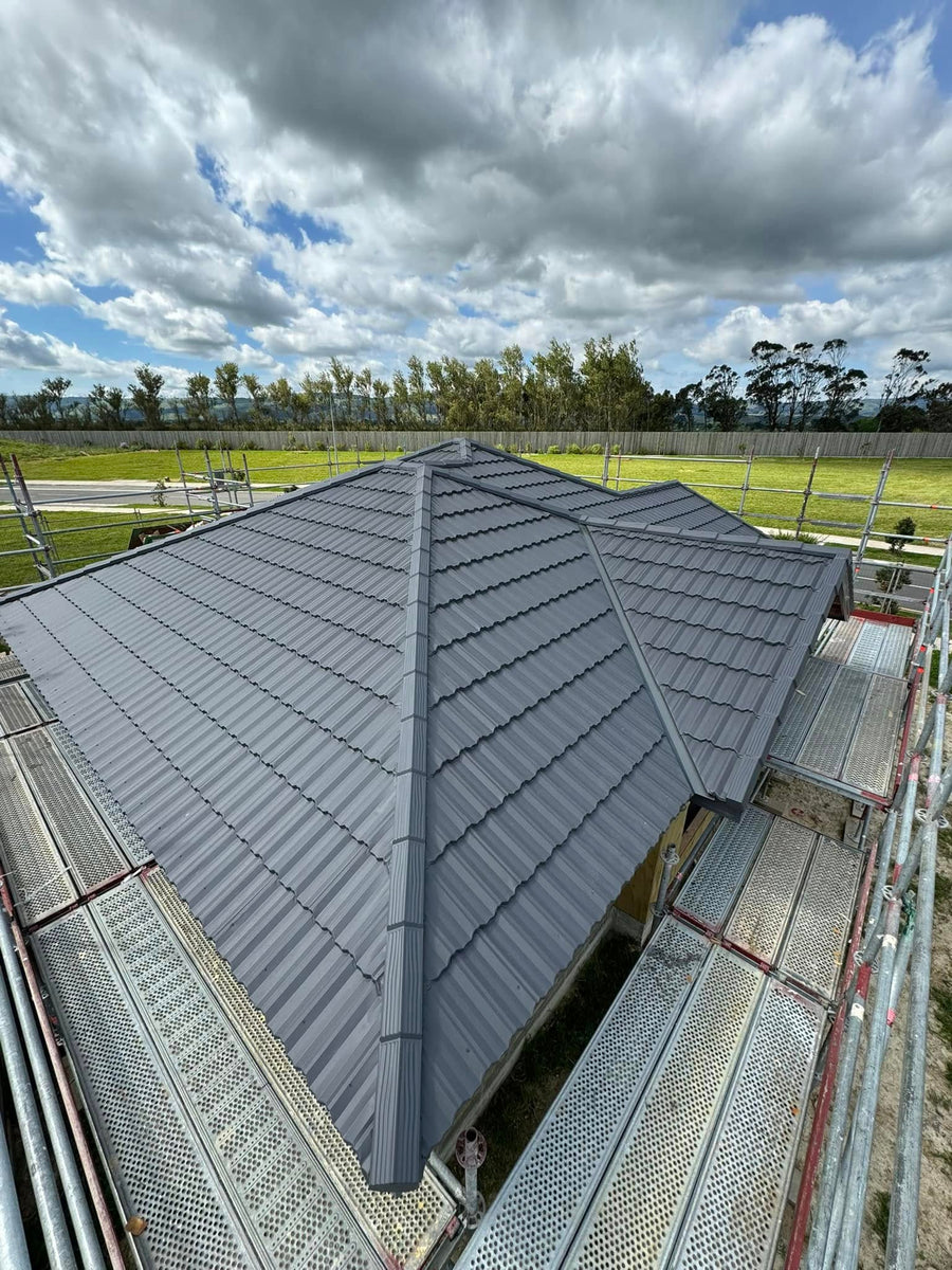 Grey metal tile roof on a new build