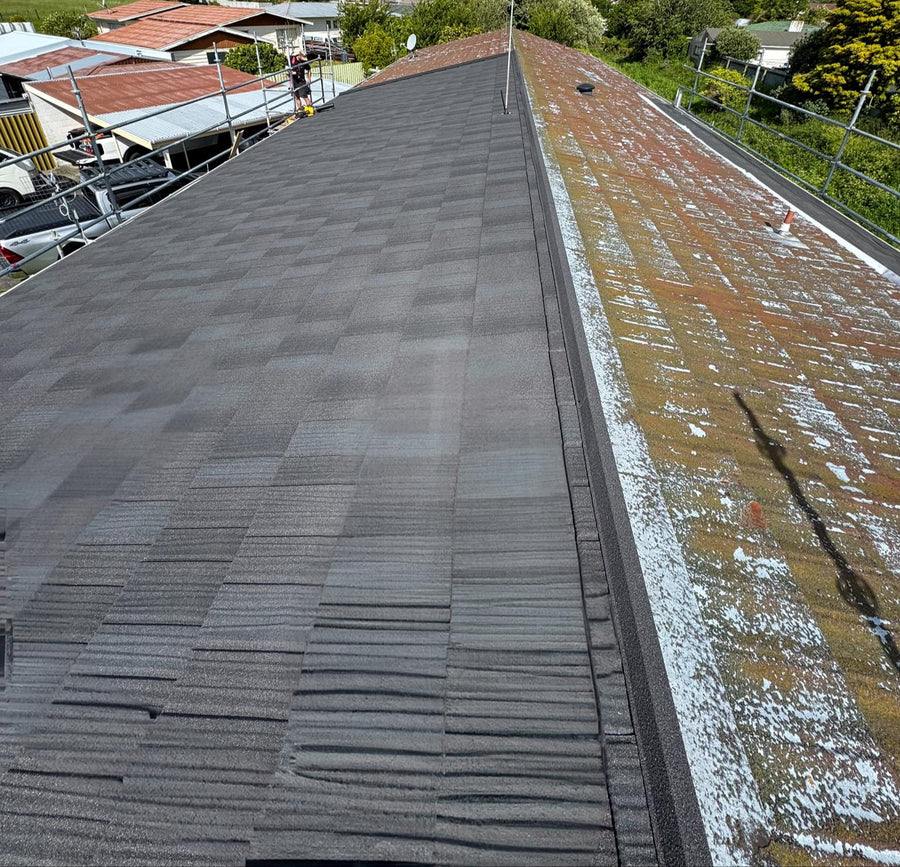 Re-roof in progress: new metal tiles replacing a moss-covered roof